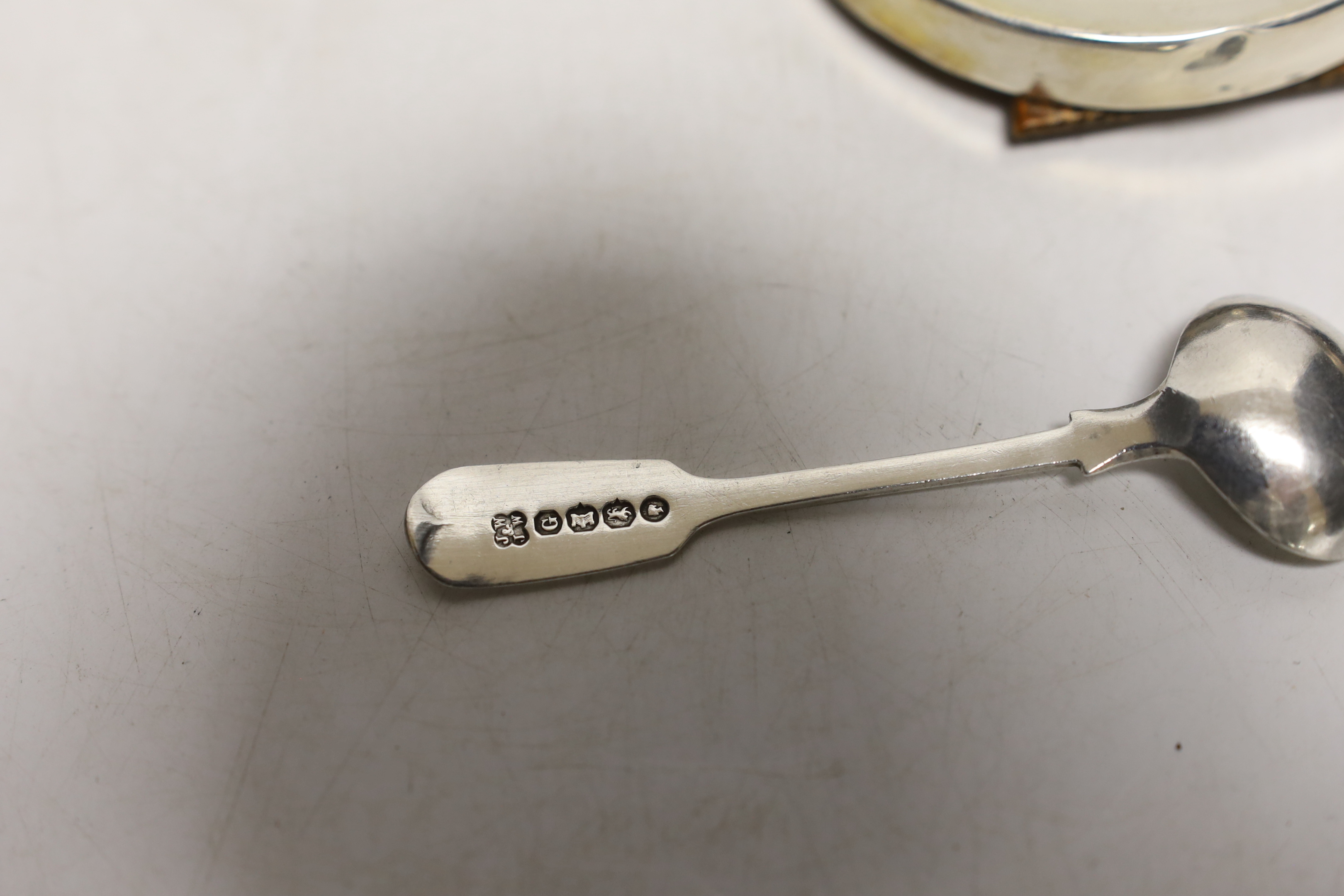 A small pair of George V silver mounted circular photograph frames, London, 1921, 75mm and four other items including a silver pill box and condiment spoon and small frame.